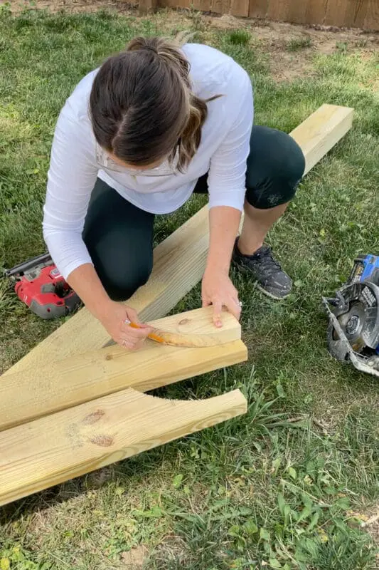 Using a jig saw to cut out wood in a backyard project.